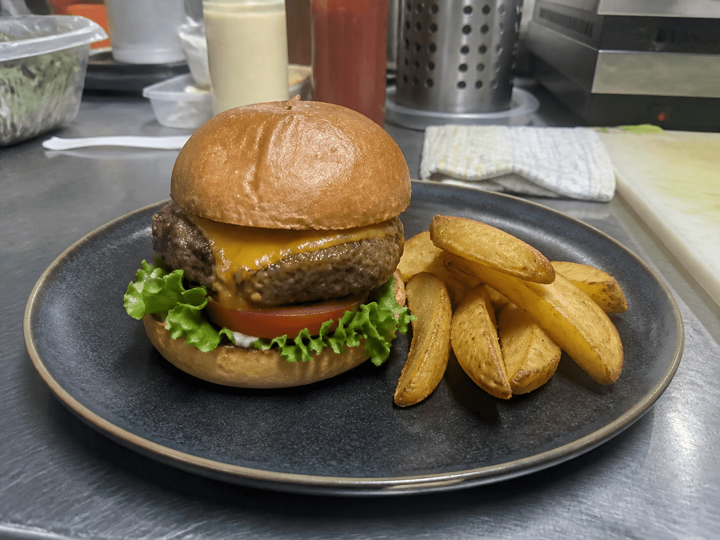 Original burger phone photo with flat lighting and a distracting kitchen background