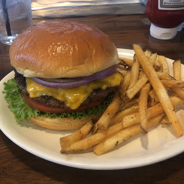Original restaurant photo of a cheeseburger and fries