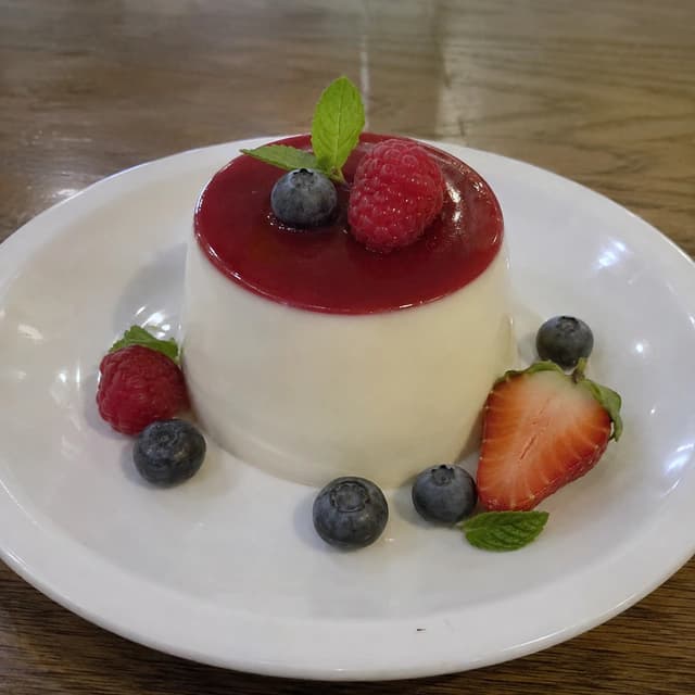 Original restaurant photo of panna cotta with berries