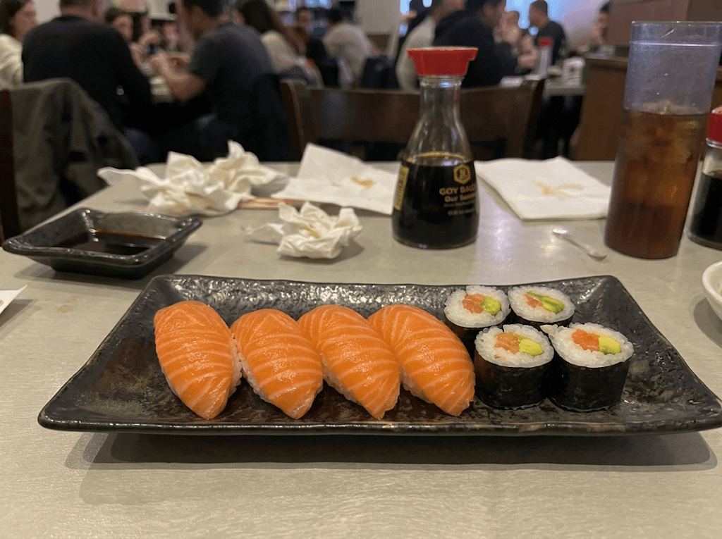 Unedited sushi photo with flat lighting and a distracting restaurant-table context